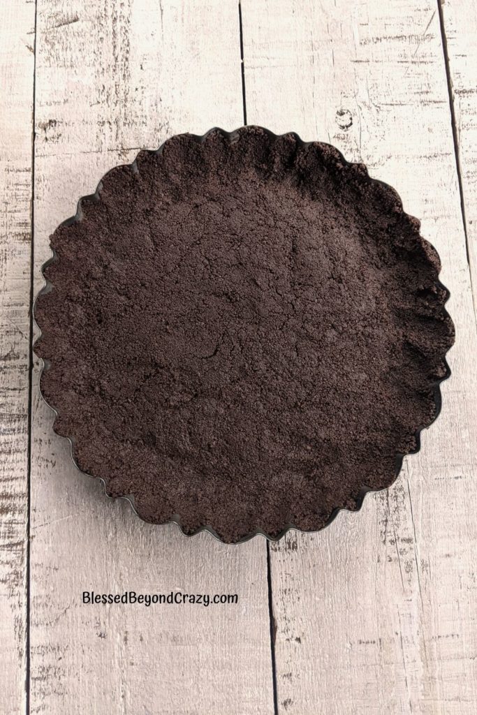 Overhead view of chocolate cookie crust in tart pan