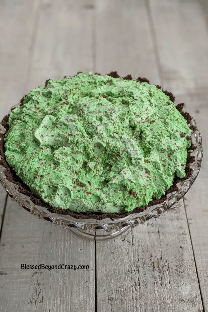 Chocolate Mint Chip Tart on pretty cake stand before spreading top with whipped topping.