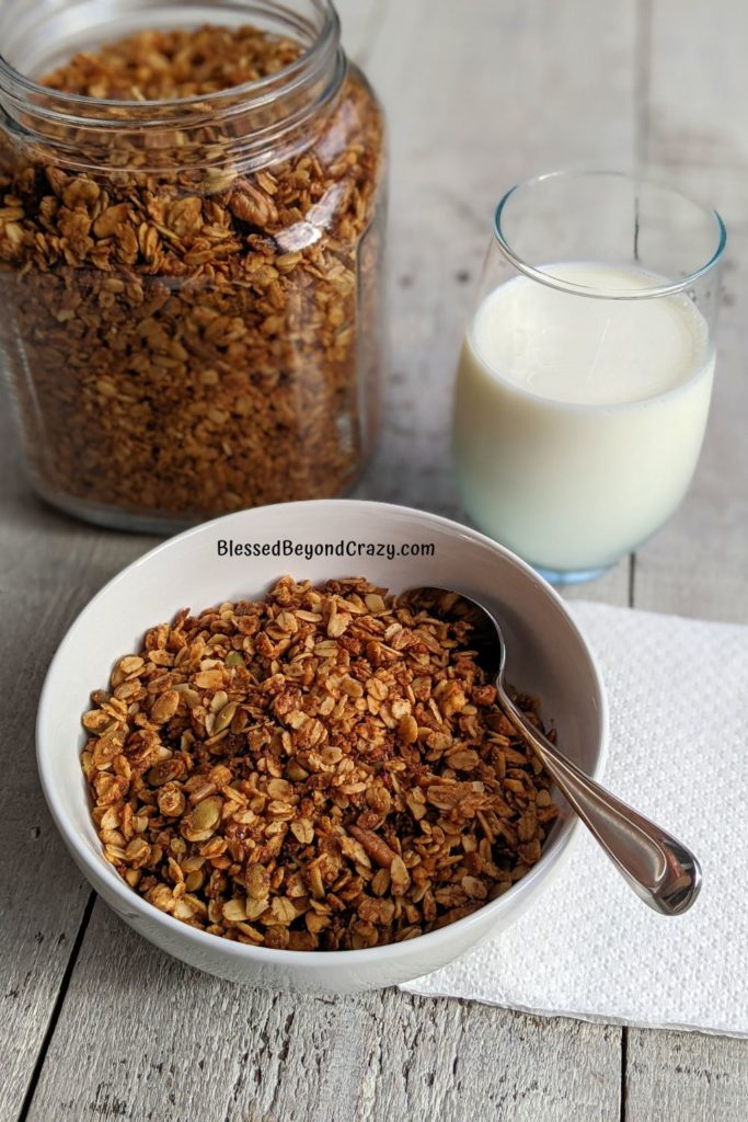 Close up view of bowl of freshly baked nutty high fiber homemade granola.