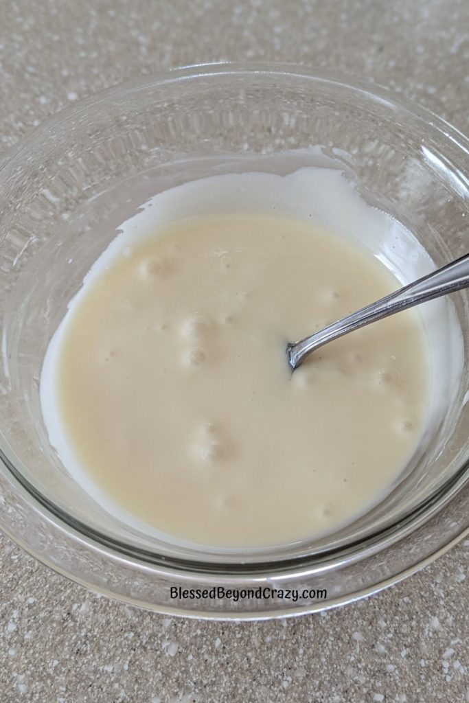 Overhead view of white glaze icing reading to drizzle over top of apple streusel cake.